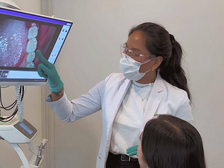 Dr. Monique Bacalla reviewing existing dental work with a patient on the chair-side screen during a second-opinion consultation at DevelopDent in Makati